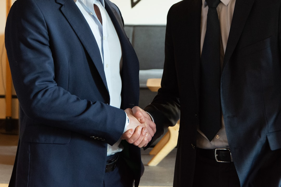 business handshake in office between banker and entrepreneur