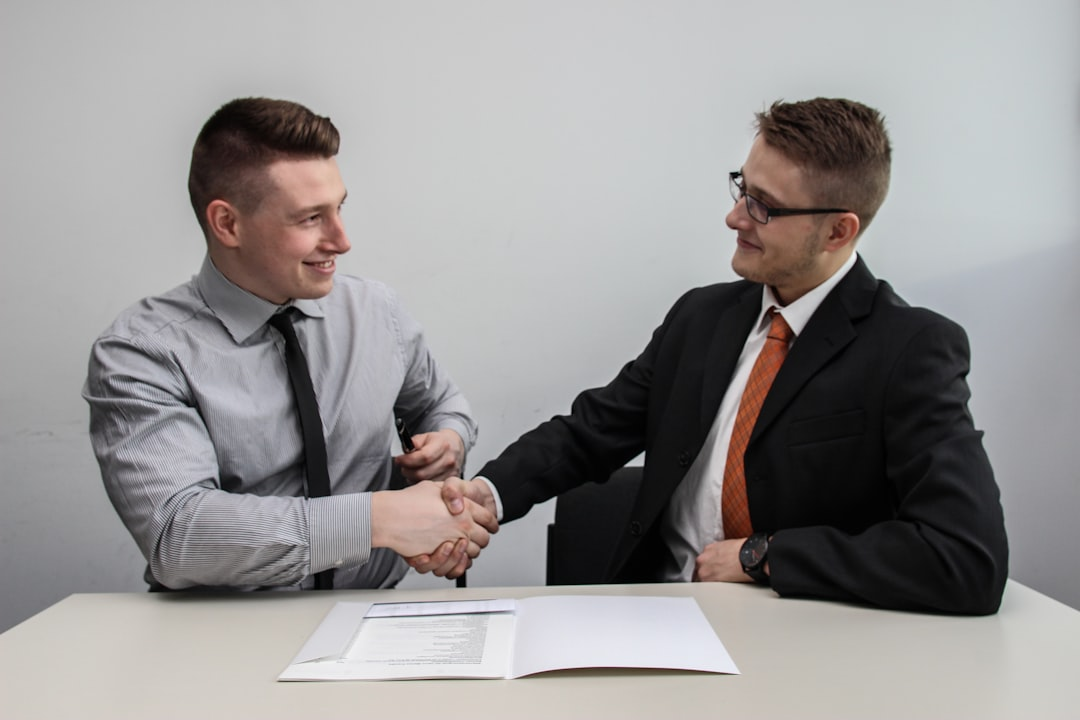 handshake signing contract business deal