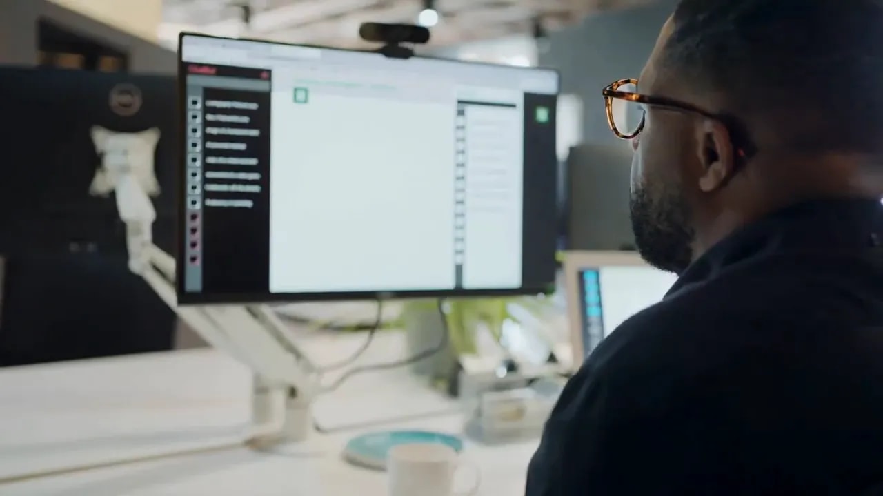 Person working at a computer with an open software screen while planning business operations
