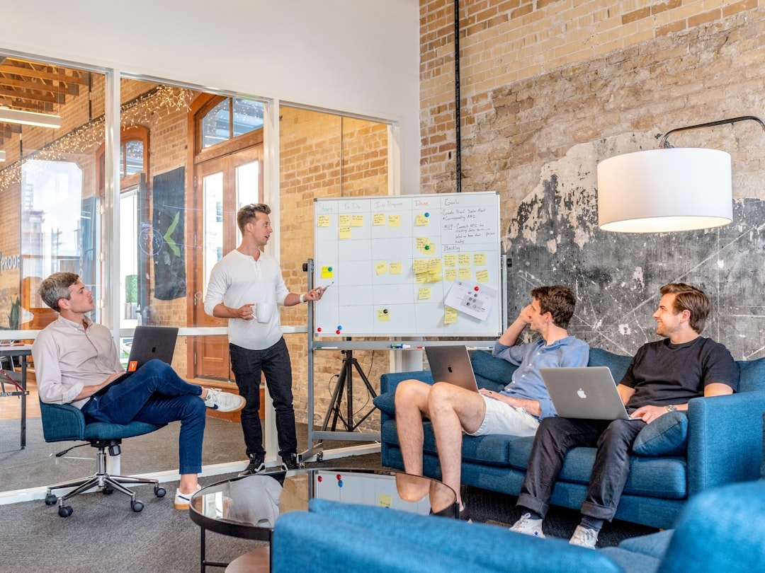 business coaching meeting laptop whiteboard