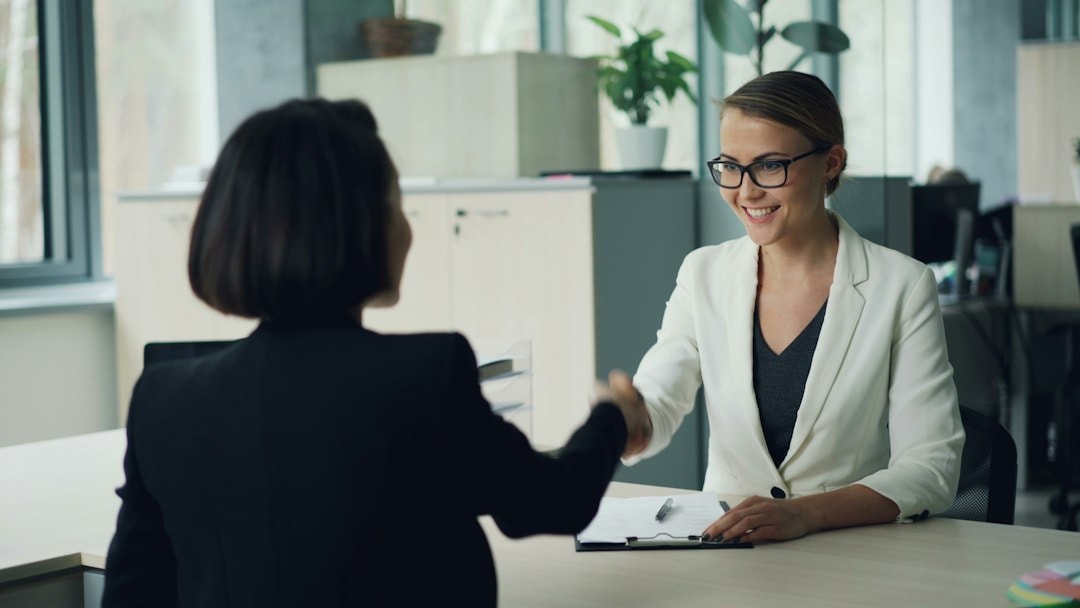 business handshake with desk