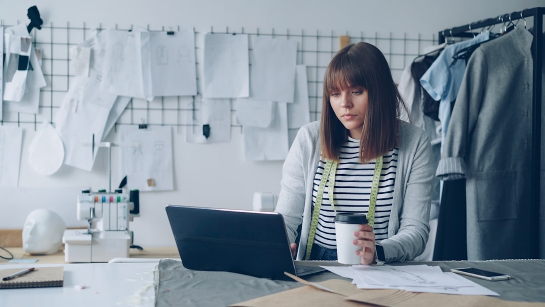business owner reviewing documents laptop desk