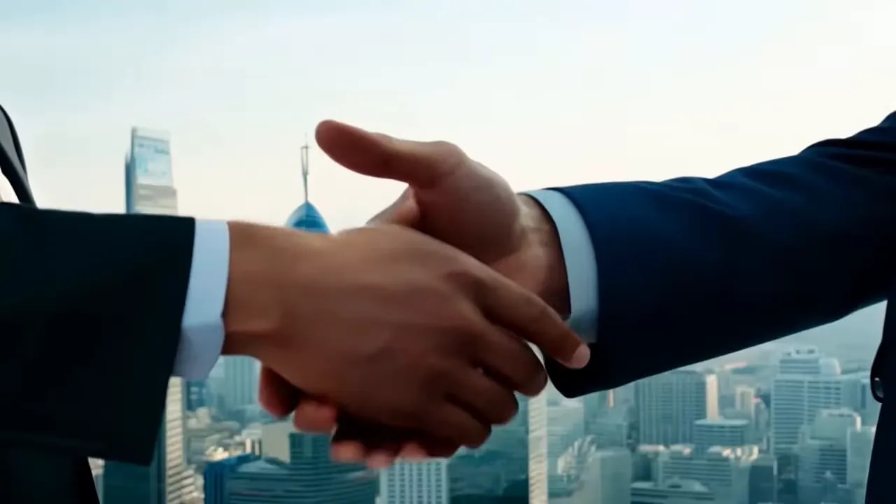 Two businesspeople shaking hands in front of a city skyline