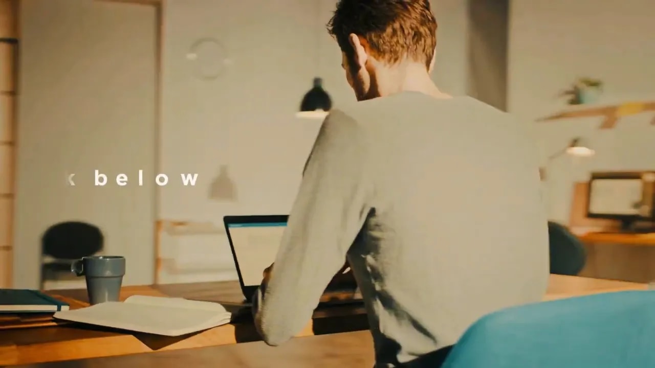 Person using a laptop at a home office desk
