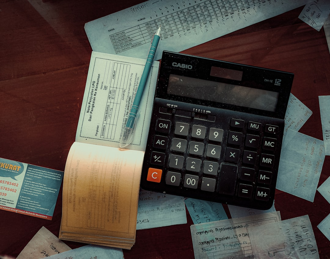 person reviewing financial documents on a desk