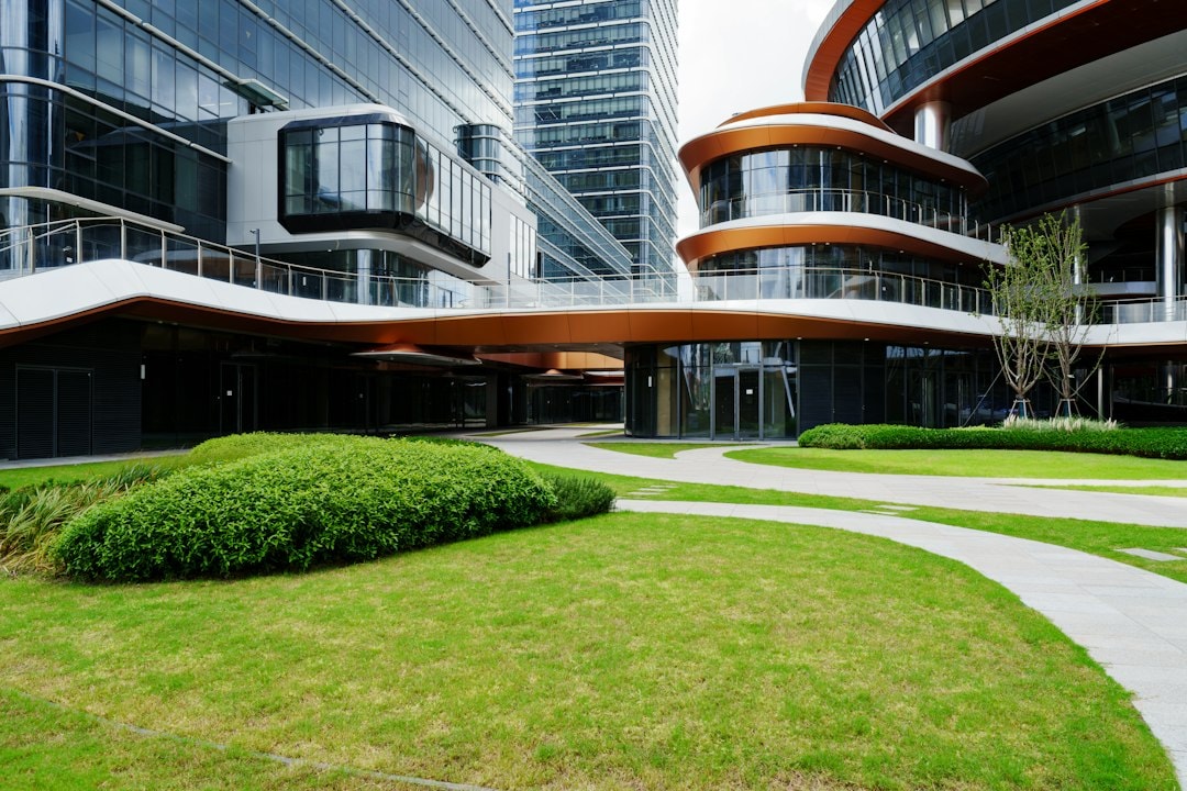 commercial landscaping contractors mowing lawn in front of office building