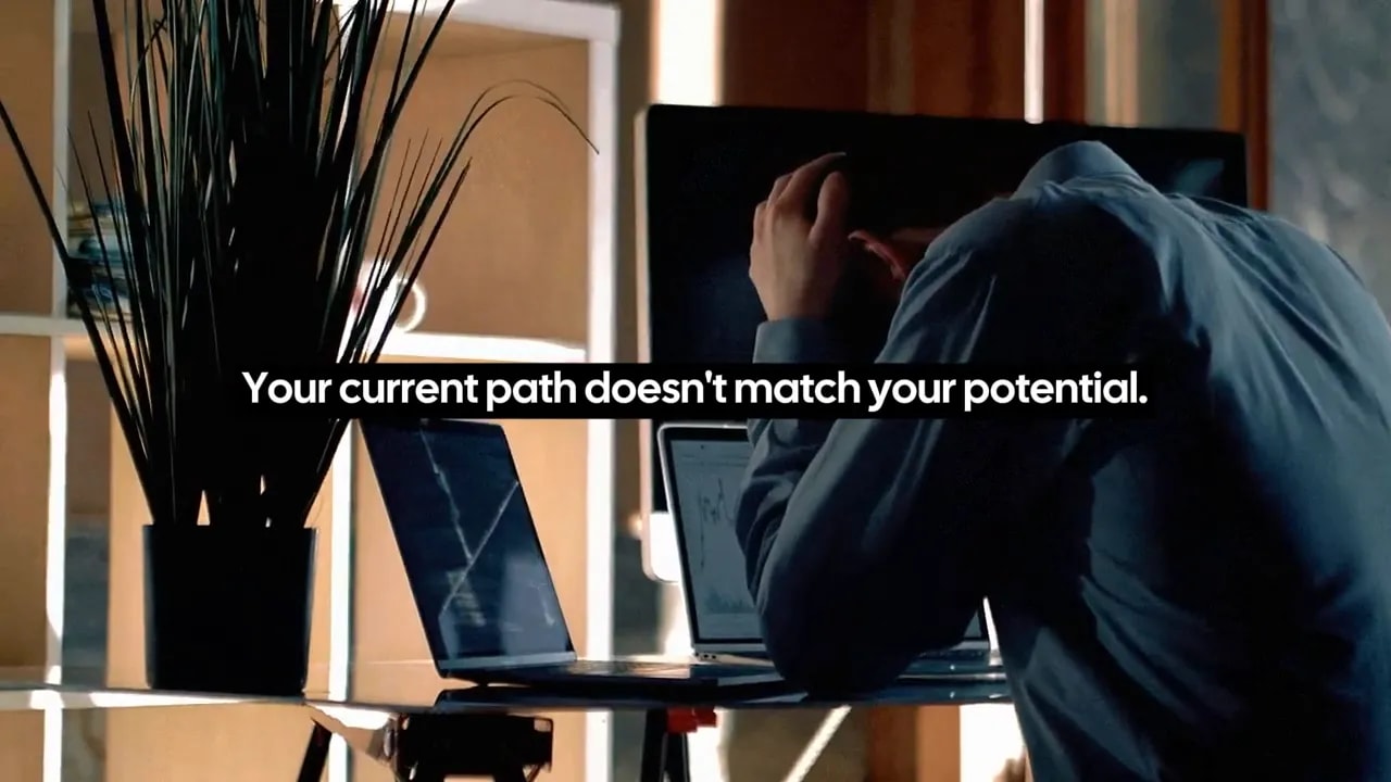 Person working at a desk with a screen showing the message, “Your current path doesn't match your potential.”