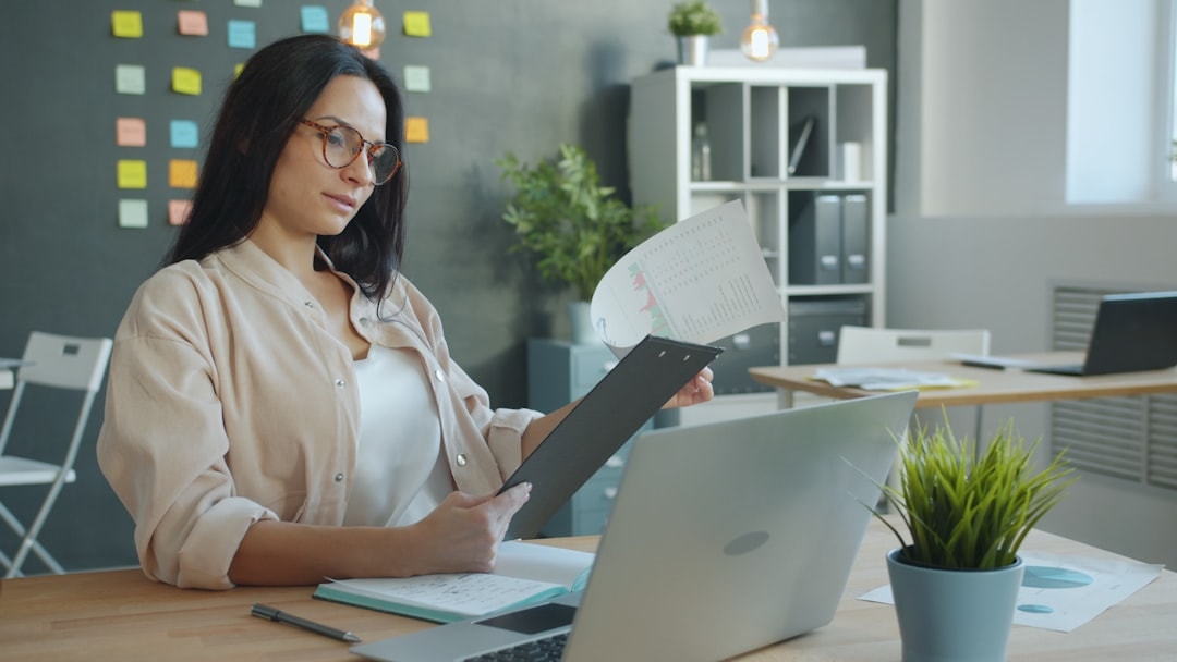 entrepreneur reviewing financial documents with laptop
