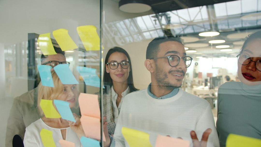 entrepreneurs discussing business plan in office glass wall stock photo