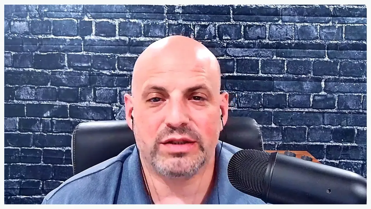 Well-lit podcast host speaking into a microphone with brick background, clear and centered