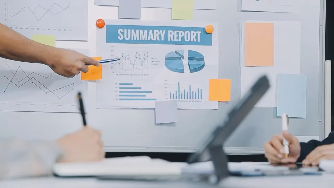 Team reviewing a summary report with charts