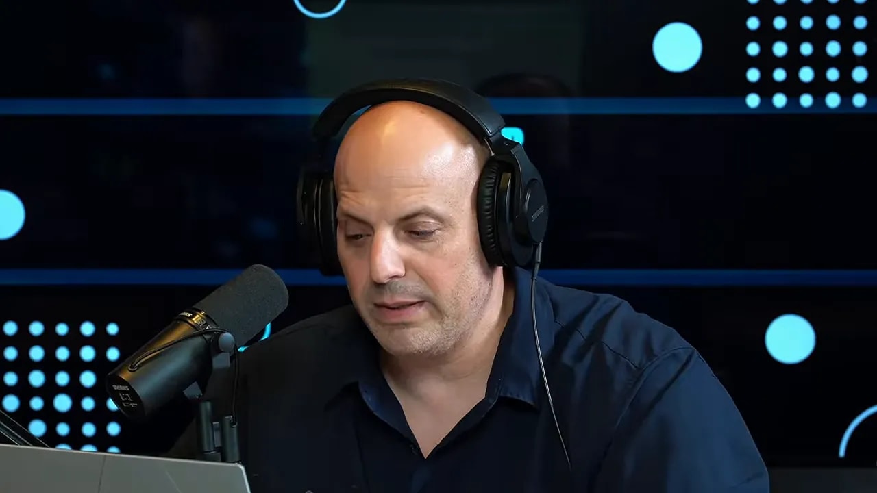 Business coach wearing headphones speaking into a microphone explaining how franchising works