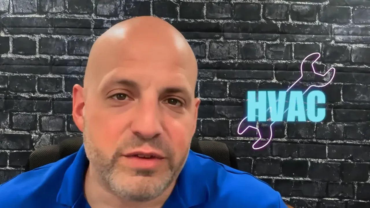 Neon HVAC text and wrench icon on a brick wall