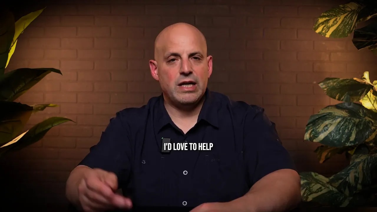 Speaker facing camera with on-screen subtitle 'I'D LOVE TO HELP'