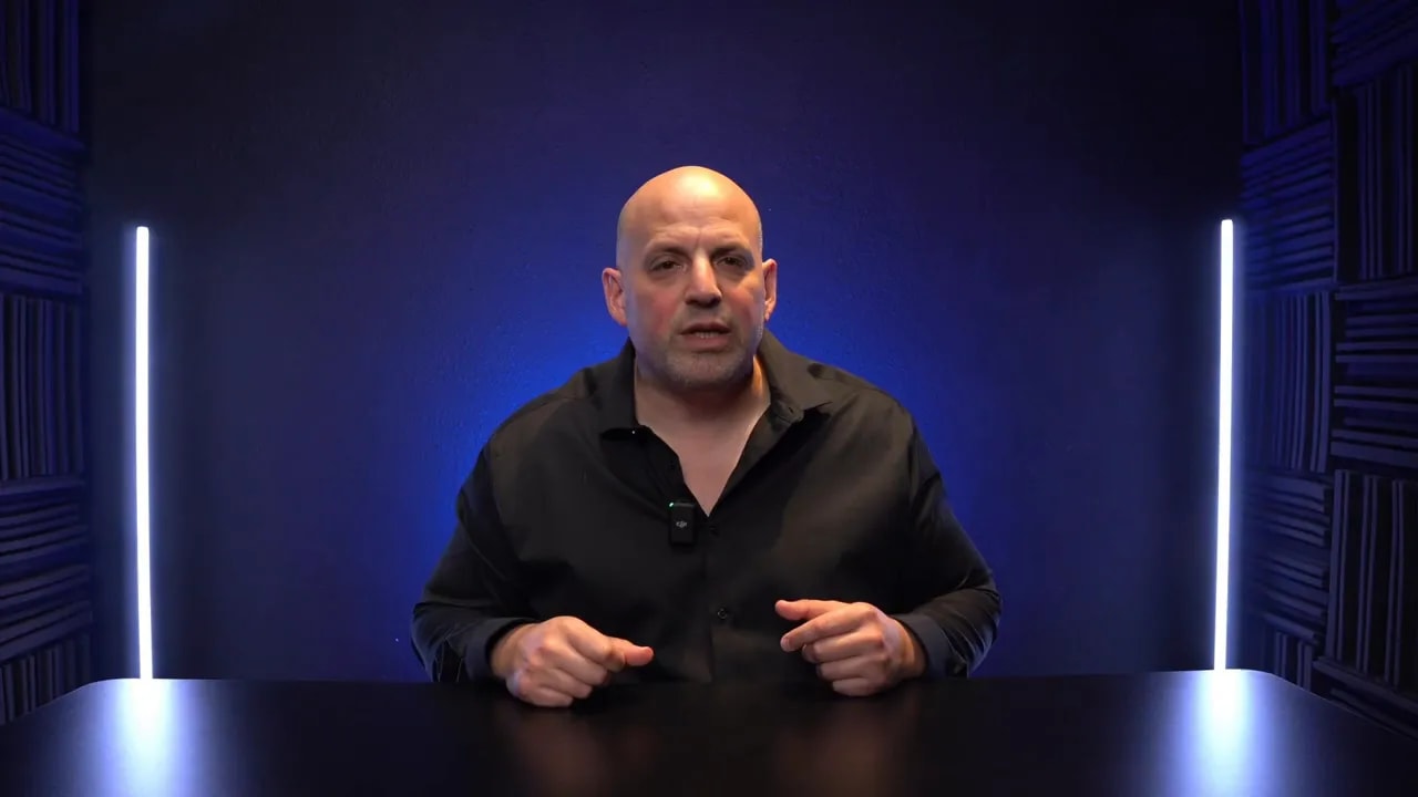 Business coach speaking about outgrowing the W-2 environment with both hands visible