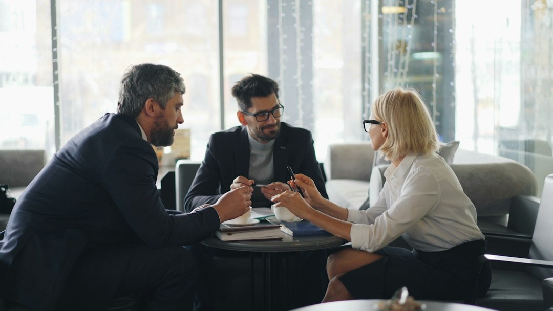 people discussing franchise agreement paperwork meeting