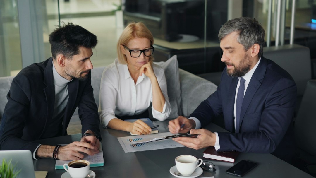 person reviewing financial documents in meeting professional