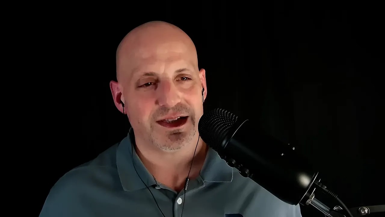 Business podcast host speaking into a microphone in a dark studio about choosing the right entity structure