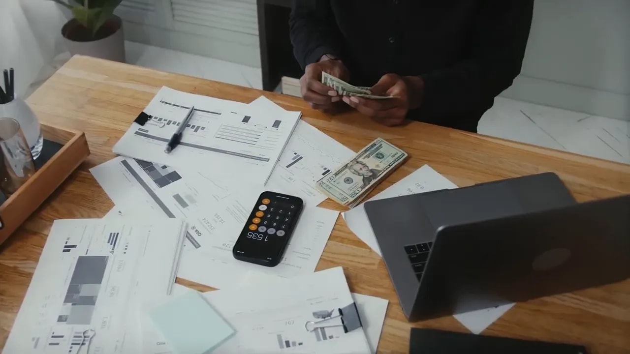Overhead view of a person reviewing paperwork at a desk
