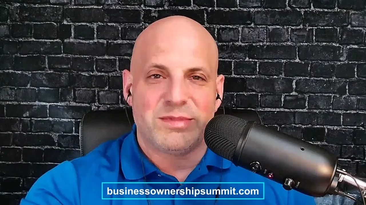 Podcast host speaking into a microphone with businessowownersinmit.com displayed on screen