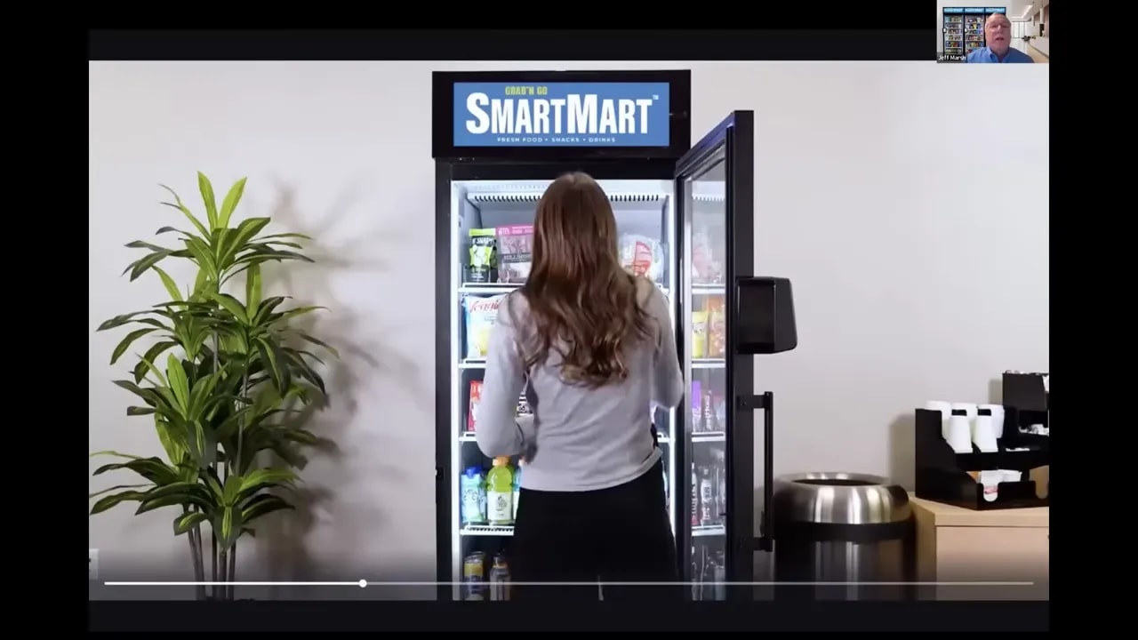 Customer selecting snacks and drinks from an open smart market cooler