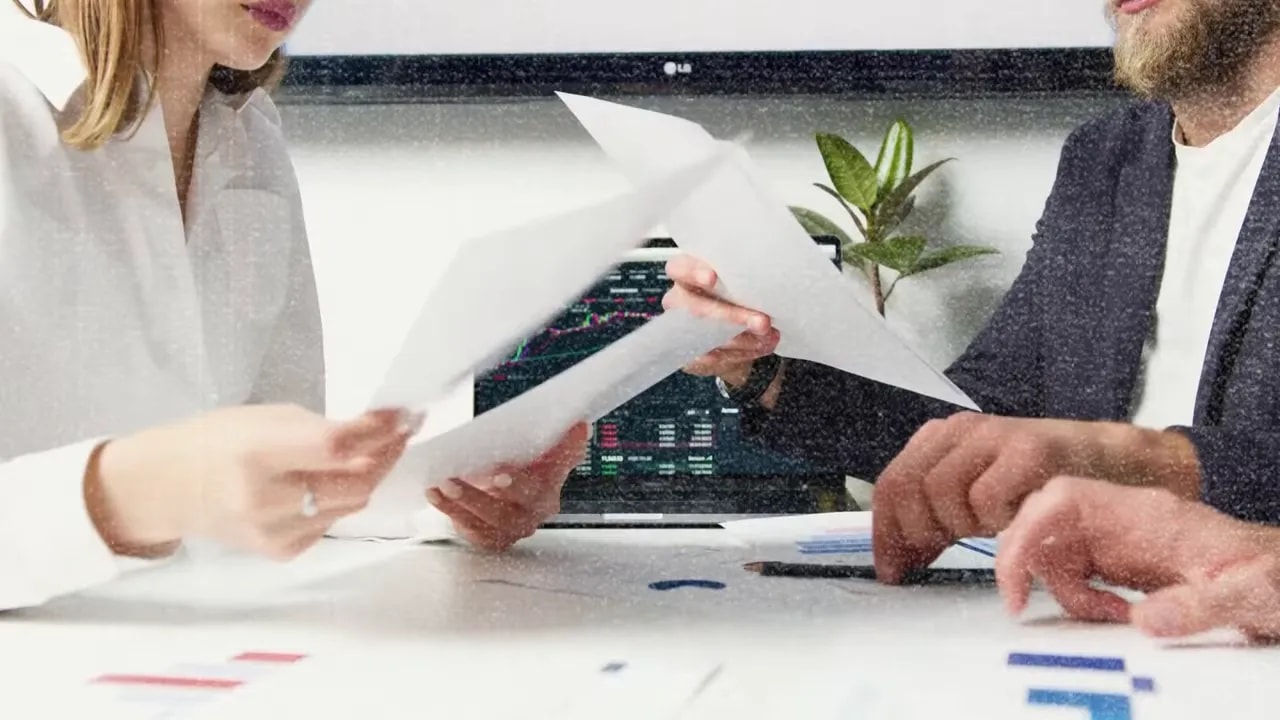 Team reviewing plans together at a desk with printed materials