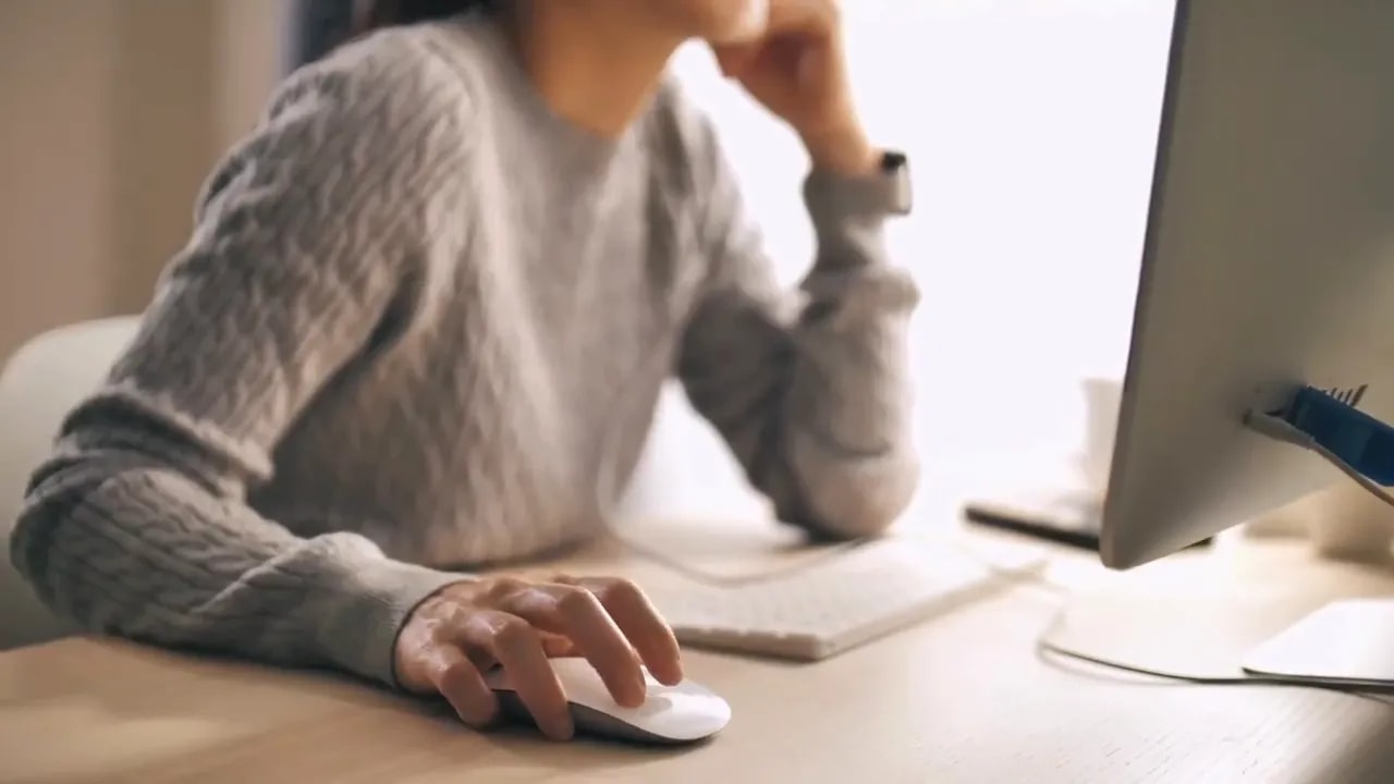 Person using a laptop while working with virtual assistant and AI productivity support
