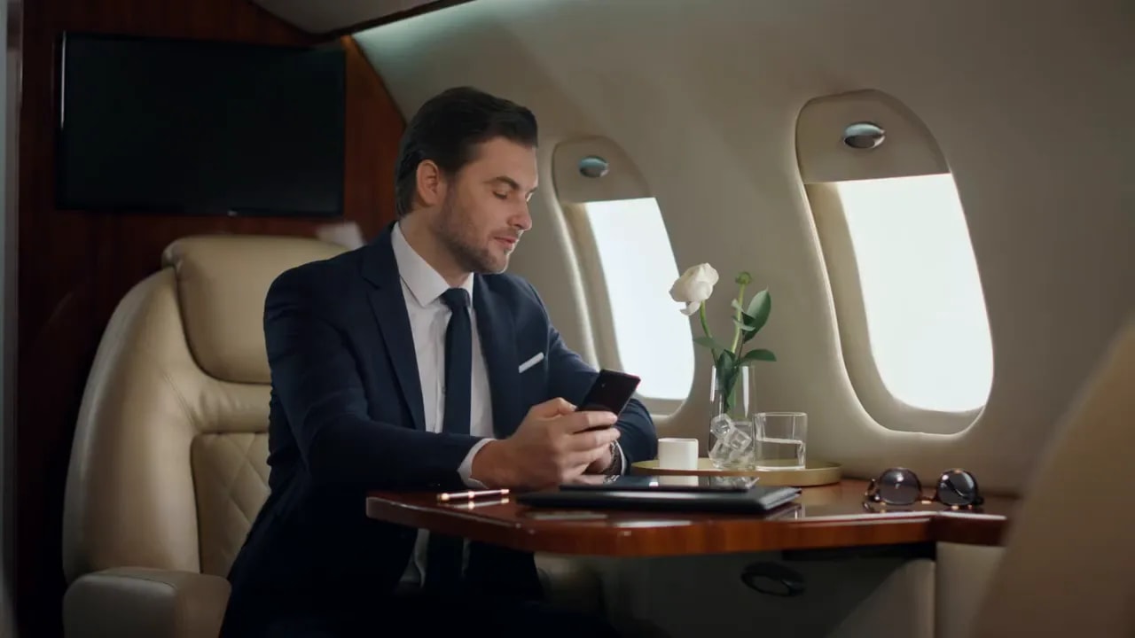 Young entrepreneur using a phone during a business-focused moment while traveling